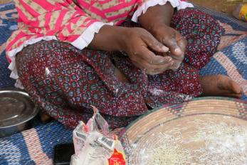 Malian hands making food.