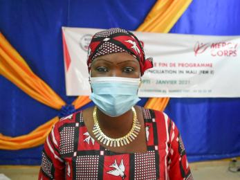 Malian woman with mask on.