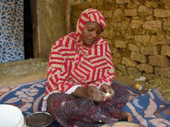 Malian woman making food.